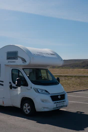 A white motor home parked in a parking lot