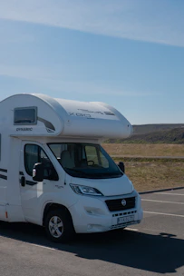 A white motor home parked in a parking lot