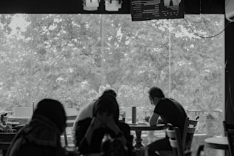 A group of people sitting at a table in a restaurant