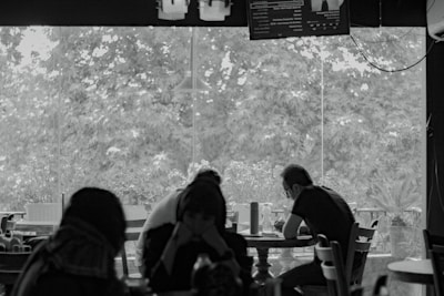 A group of people sitting at a table in a restaurant