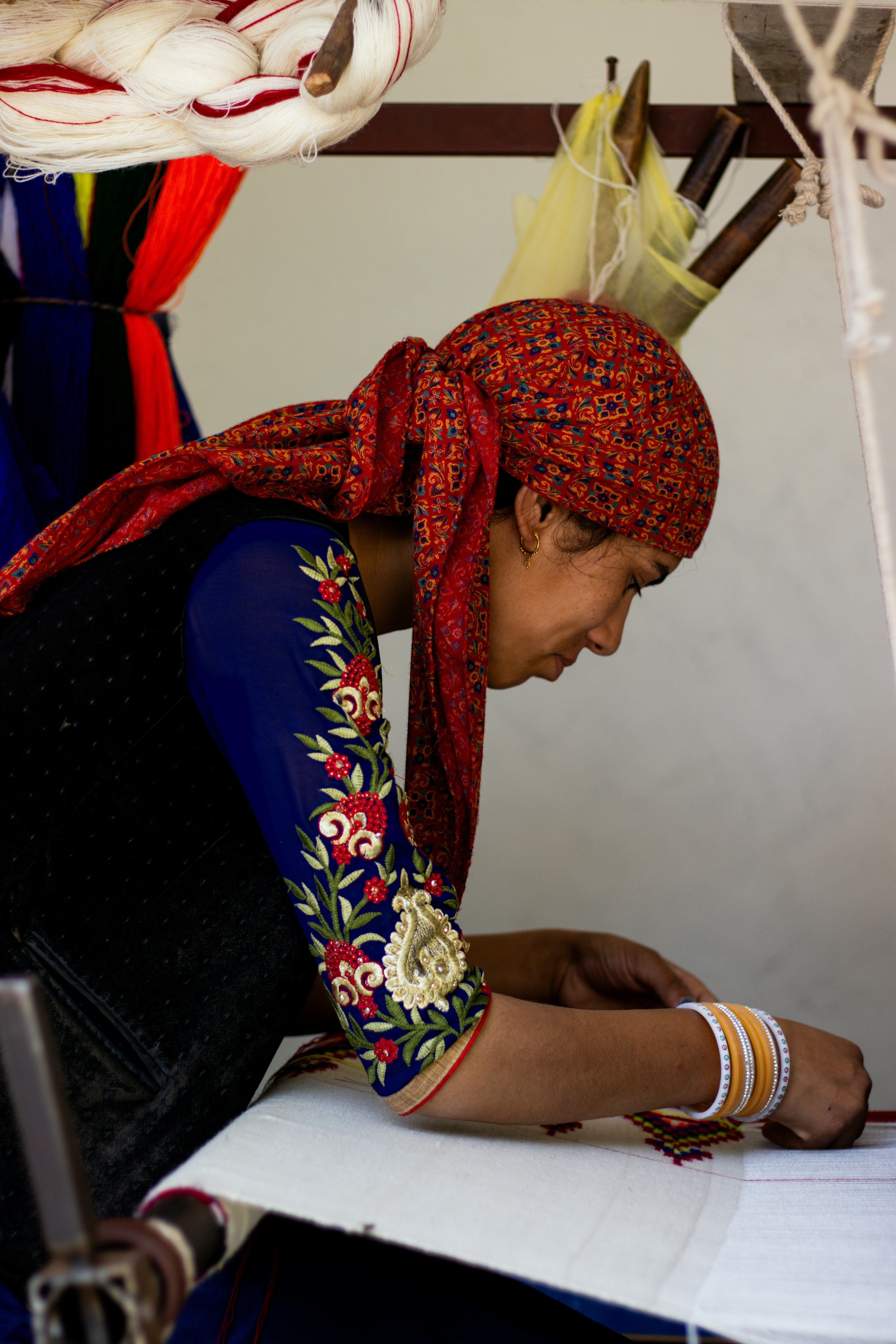A woman sitting at a table working on a piece of paper
