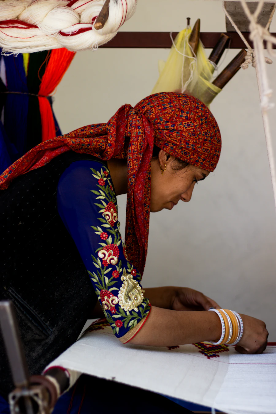 An artisan reviewing paperwork at a work table