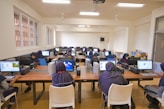 A group of people sitting at desk with laptops
