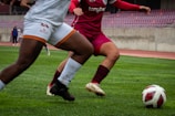 A couple of women playing a game of soccer