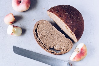 A sliced loaf of bread next to a knife