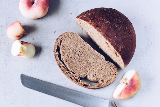 A sliced loaf of bread next to a knife
