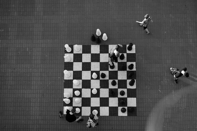 Two chess players facing off over a board in an intense match