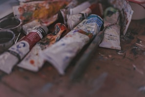 A bunch of paint and some scissors on a table