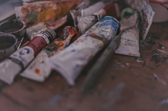 A bunch of paint and some scissors on a table