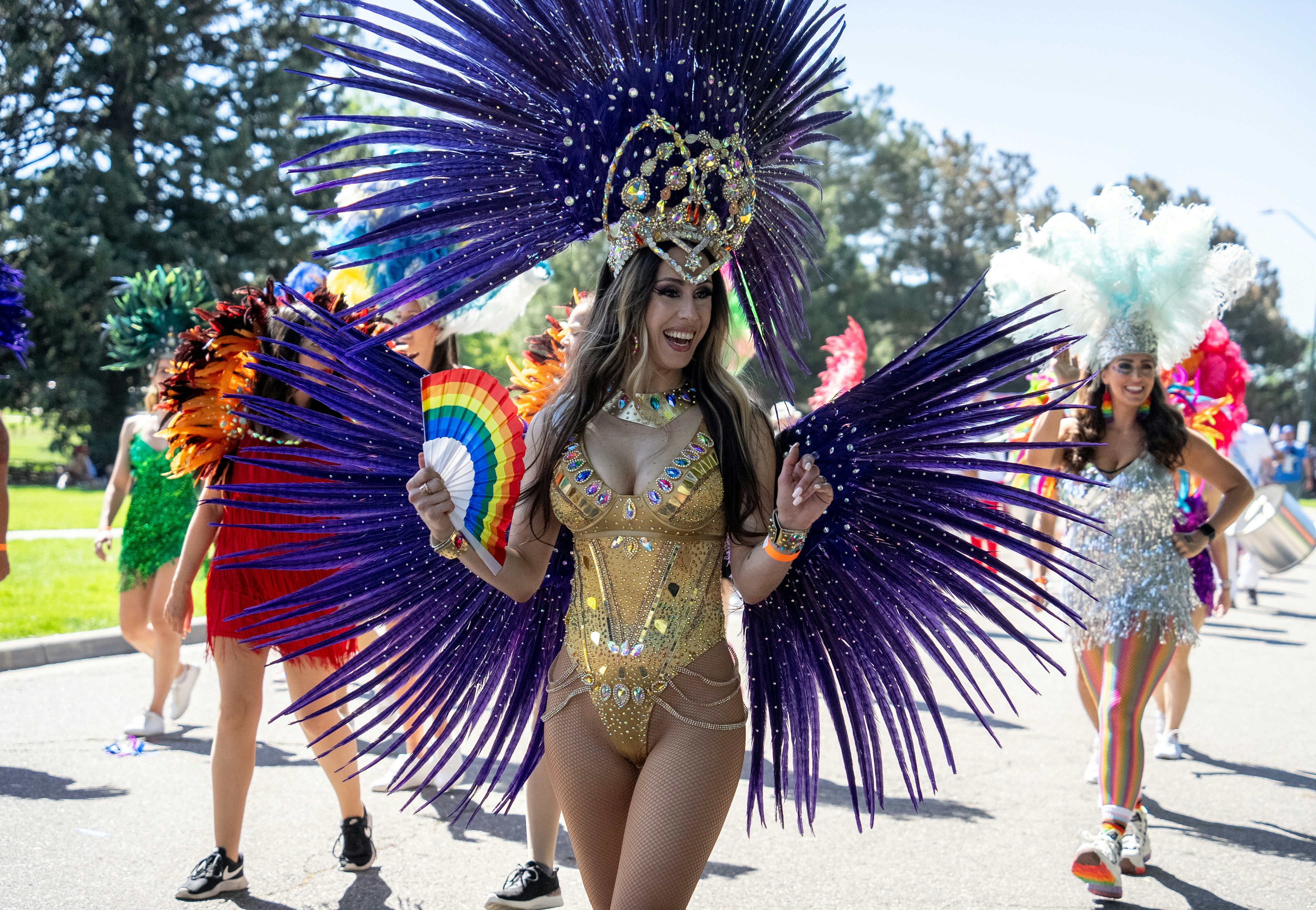 Carnival queen in gold and red feathered costume at parade