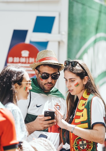 A man and a woman looking at a cell phone