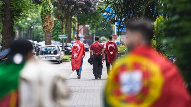 A group of people walking down a street