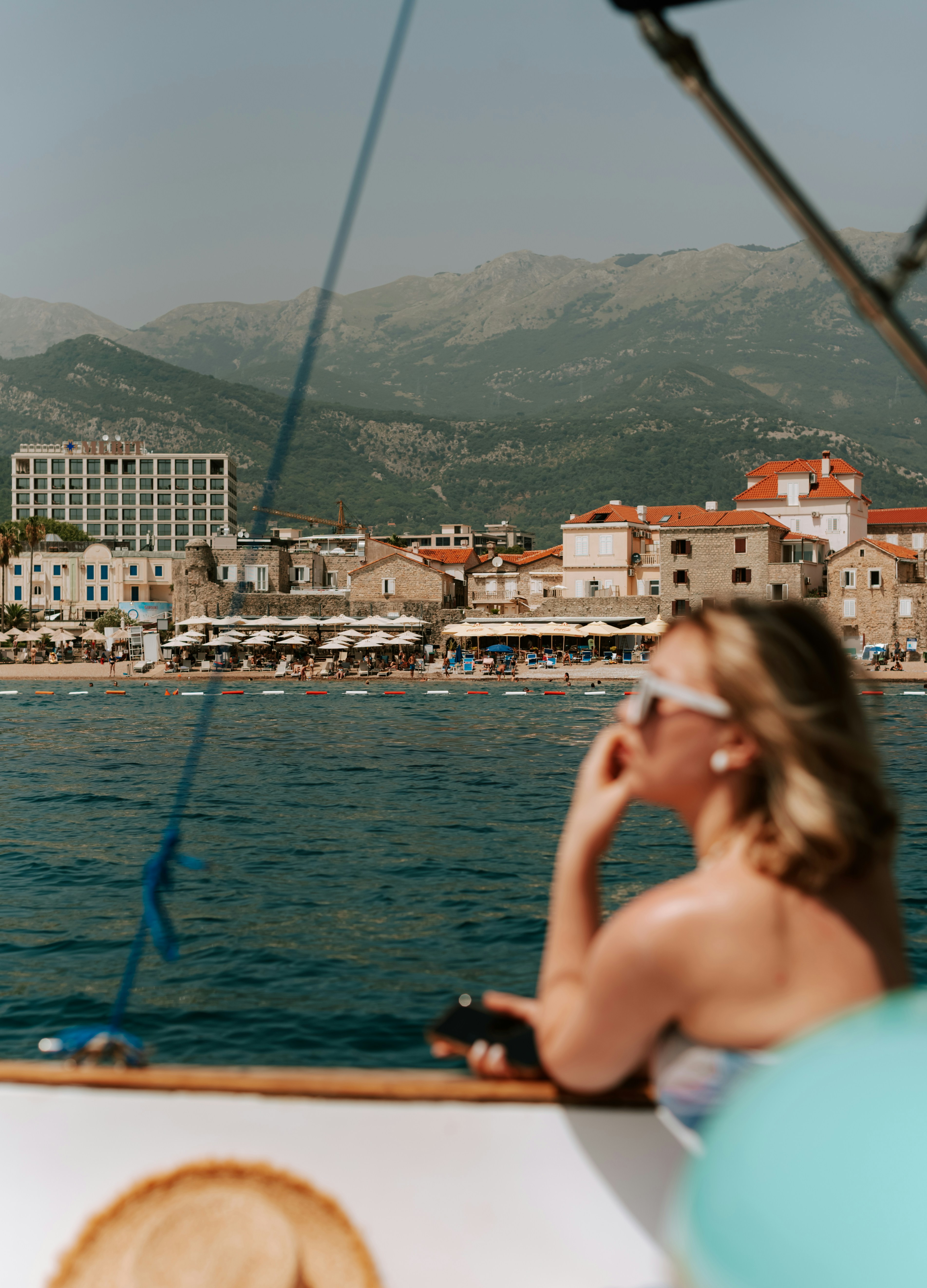 A woman sitting on a boat in the water photo – Free Grey Image on Unsplash