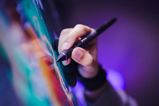 A person writing on a piece of paper with a pen