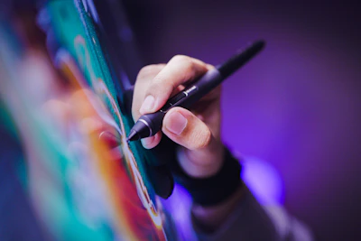 A person writing on a piece of paper with a pen