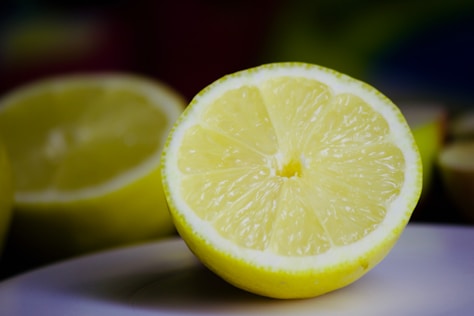 A close up of a sliced lemon on a plate