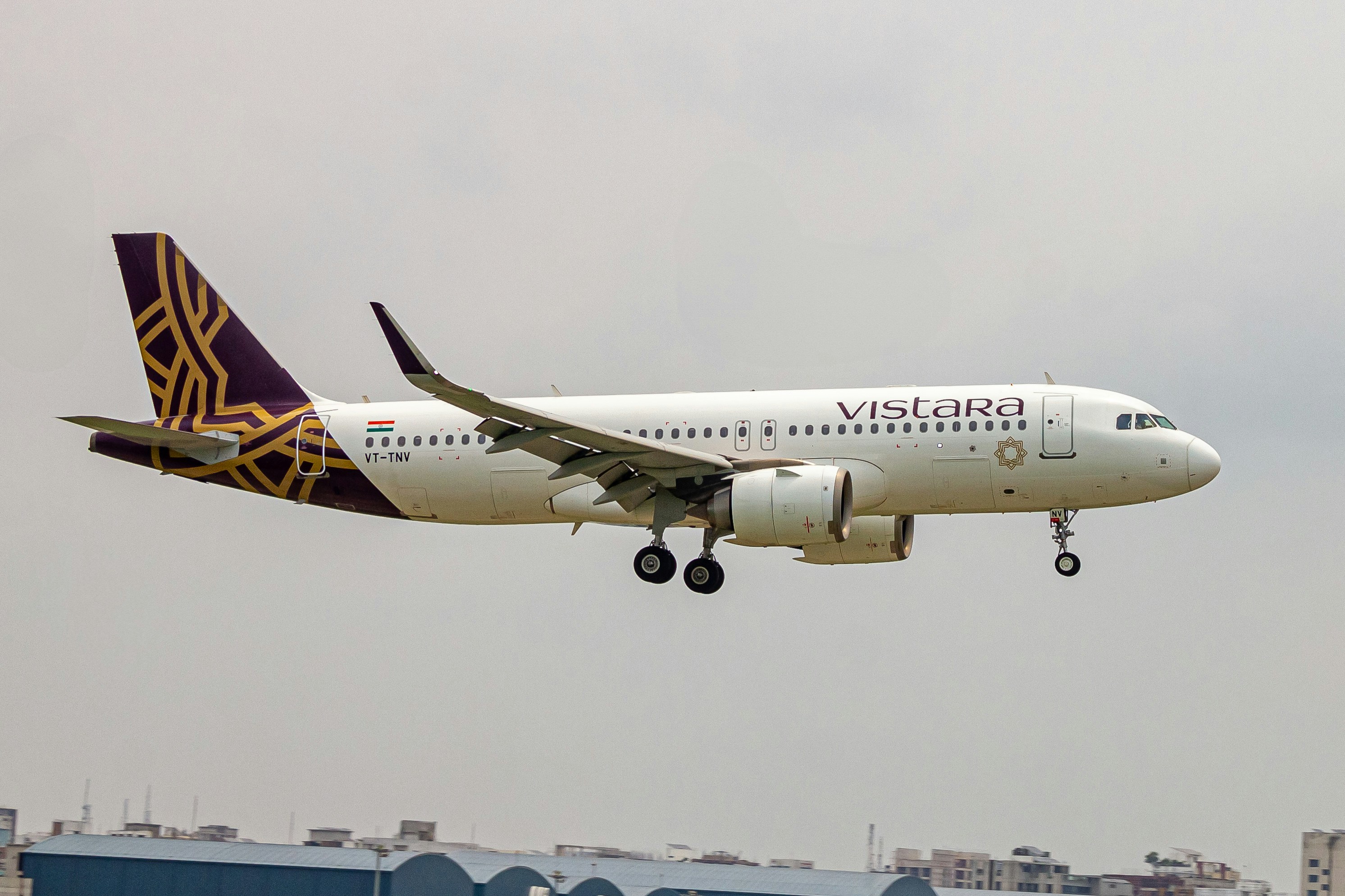 A large jetliner flying through a cloudy sky