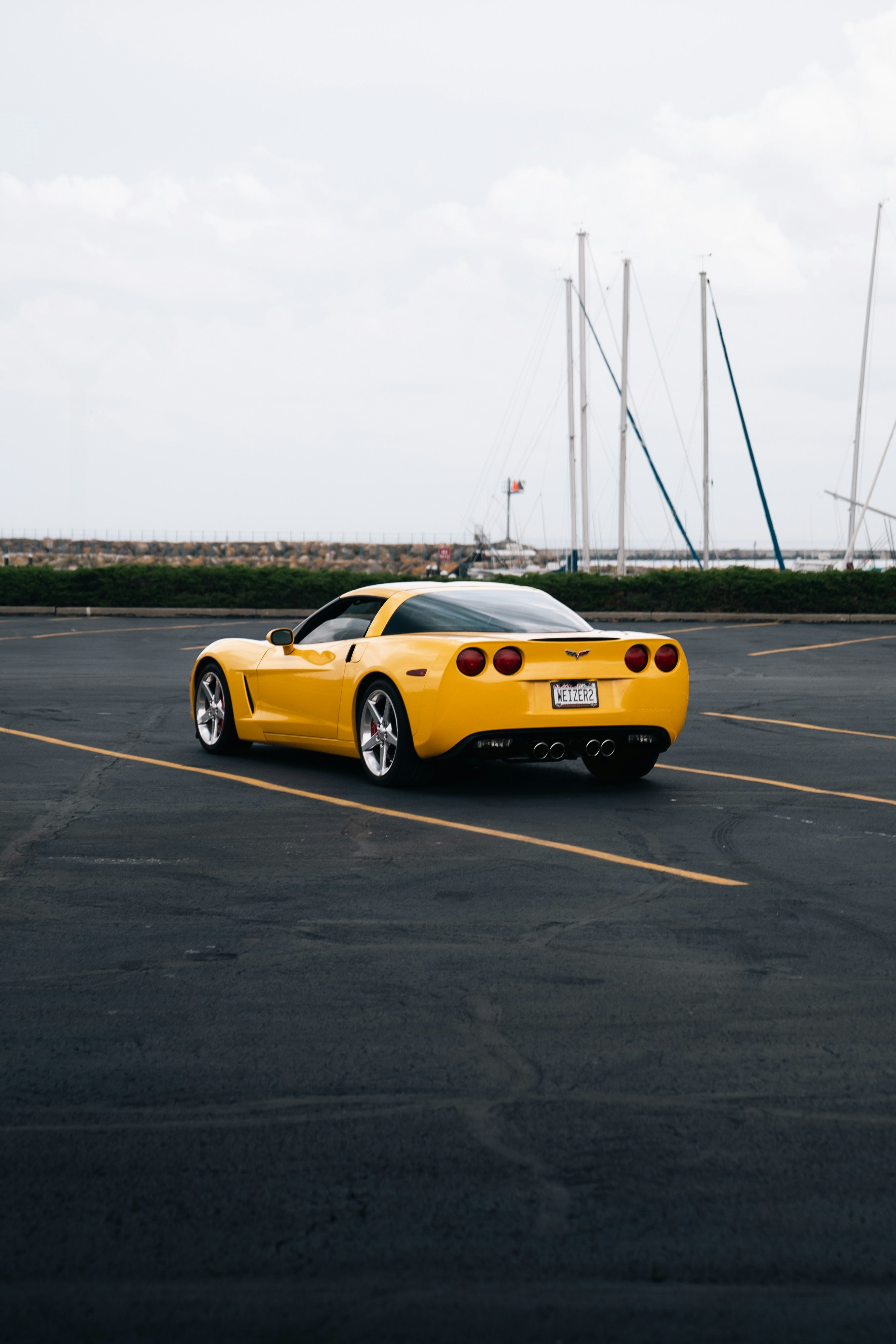 A yellow sports car parked in a parking lot