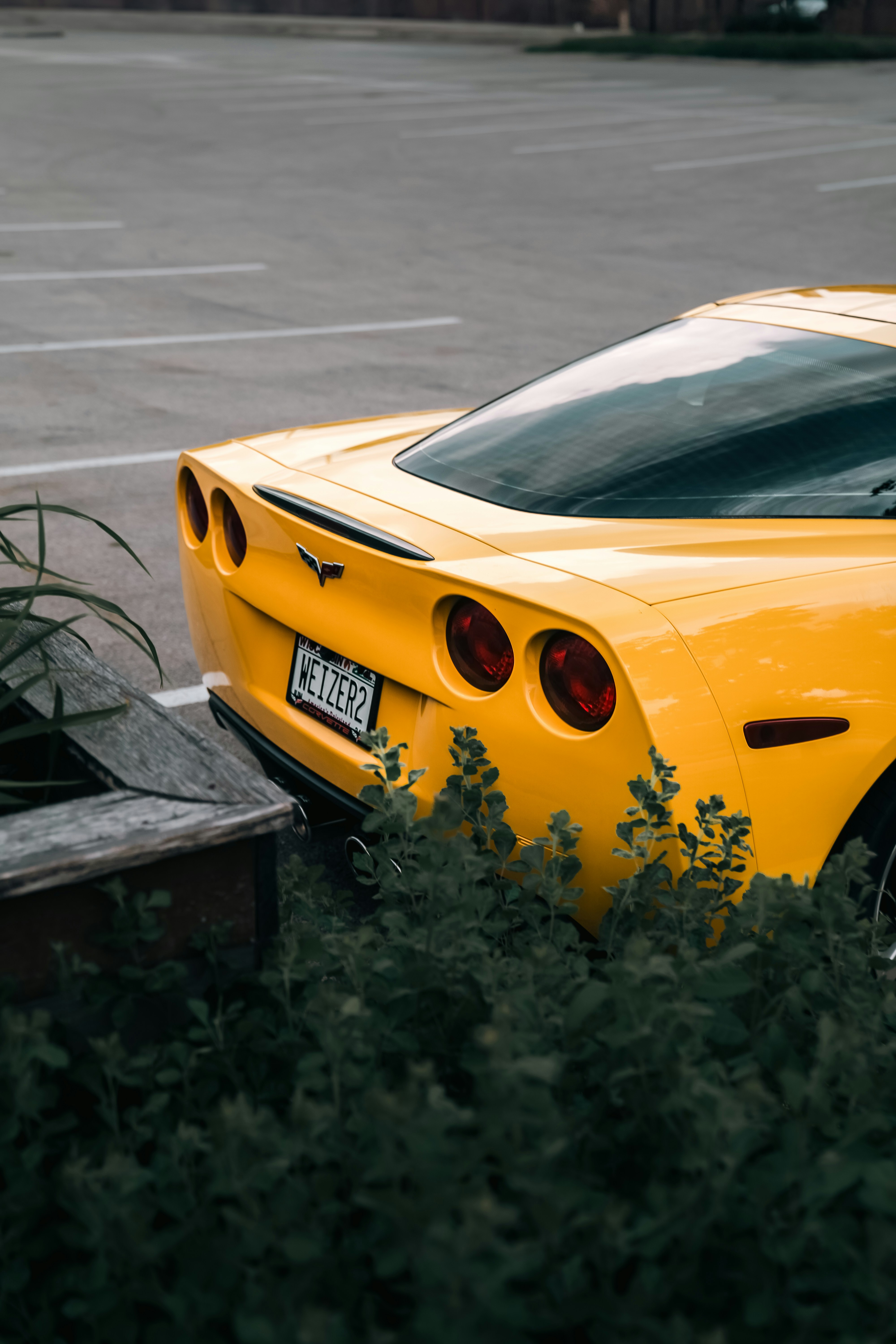 A yellow sports car parked in a parking lot