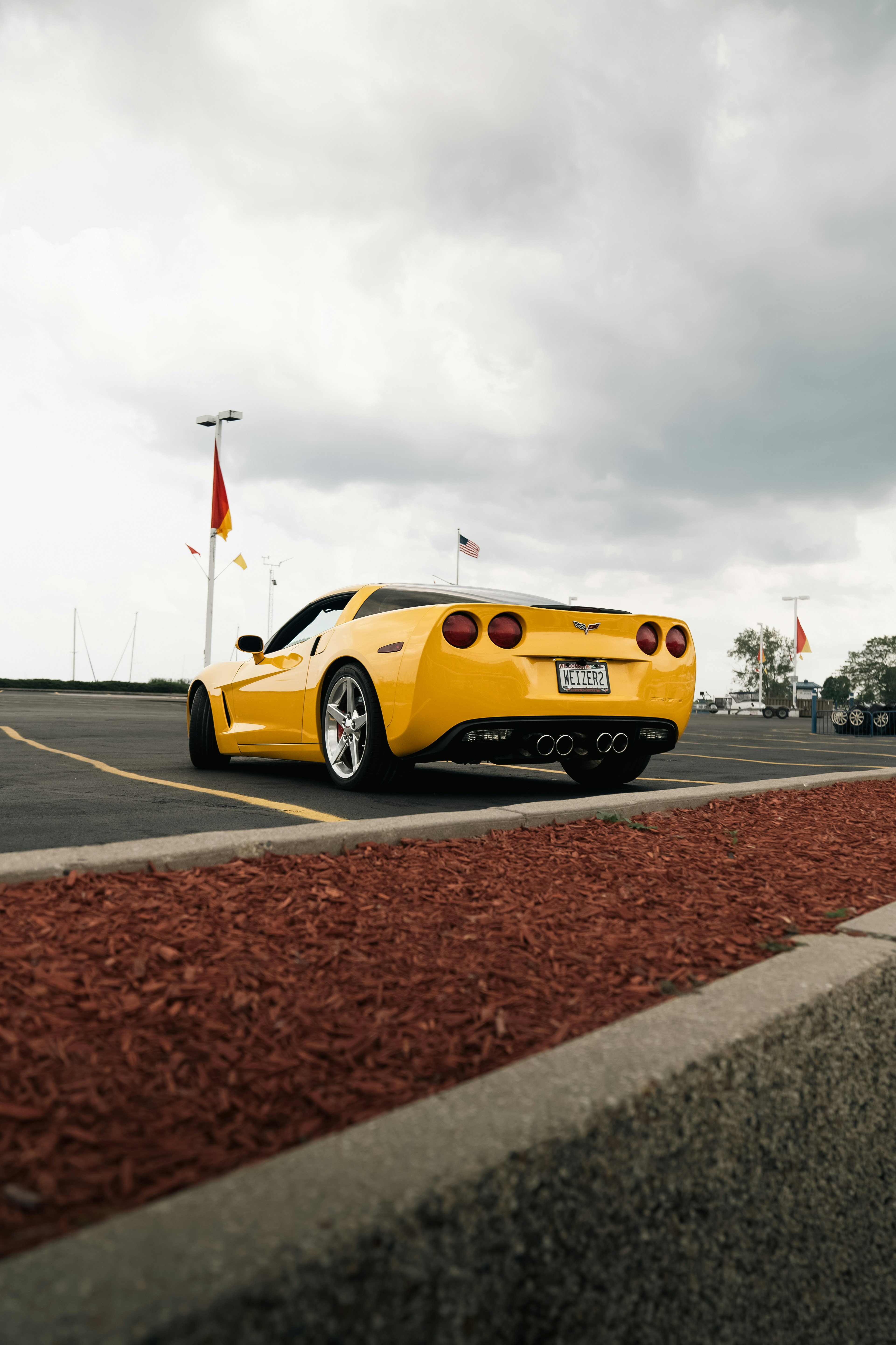 A yellow sports car parked in a parking lot