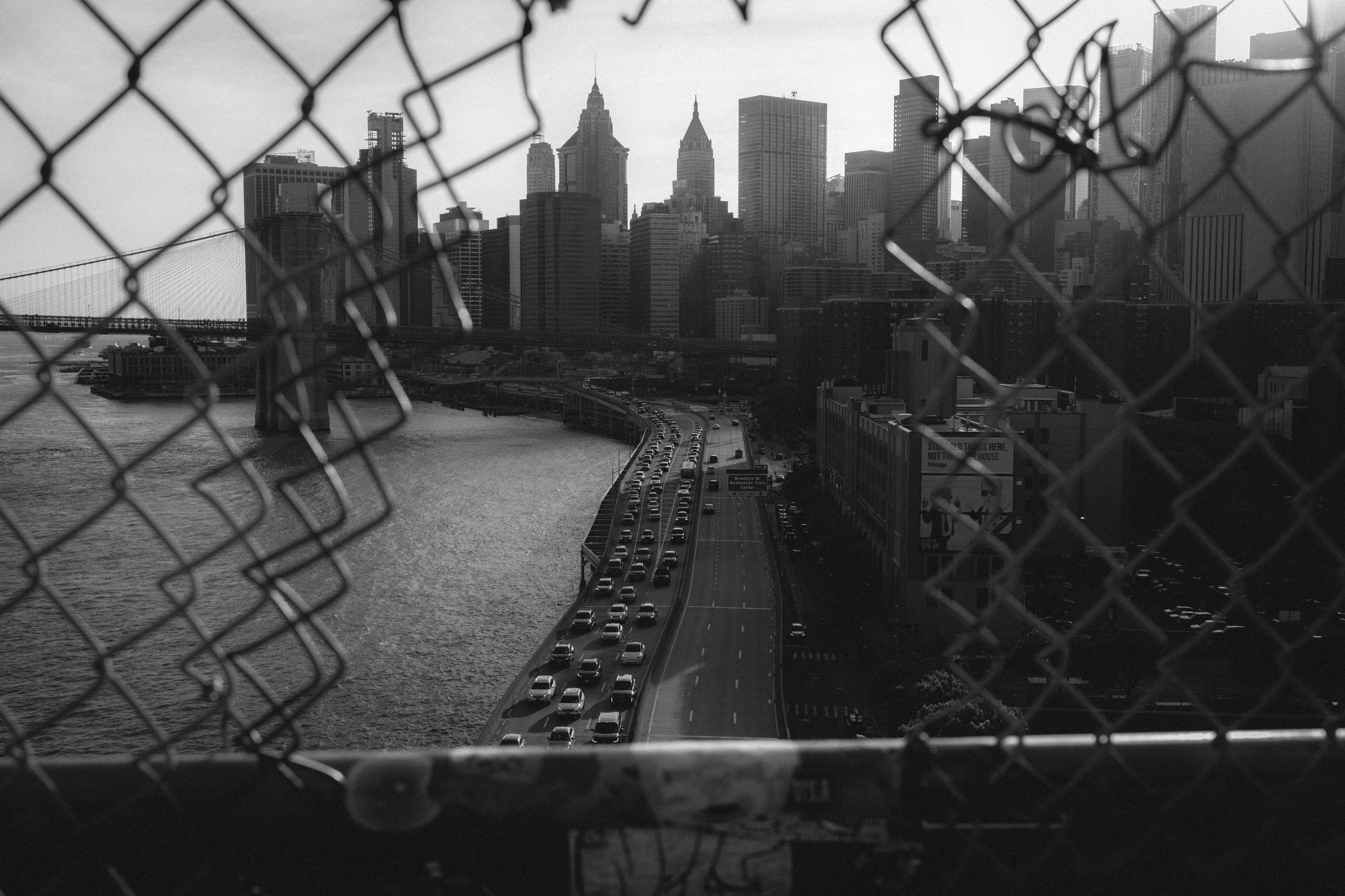 A view of a city through a chain link fence