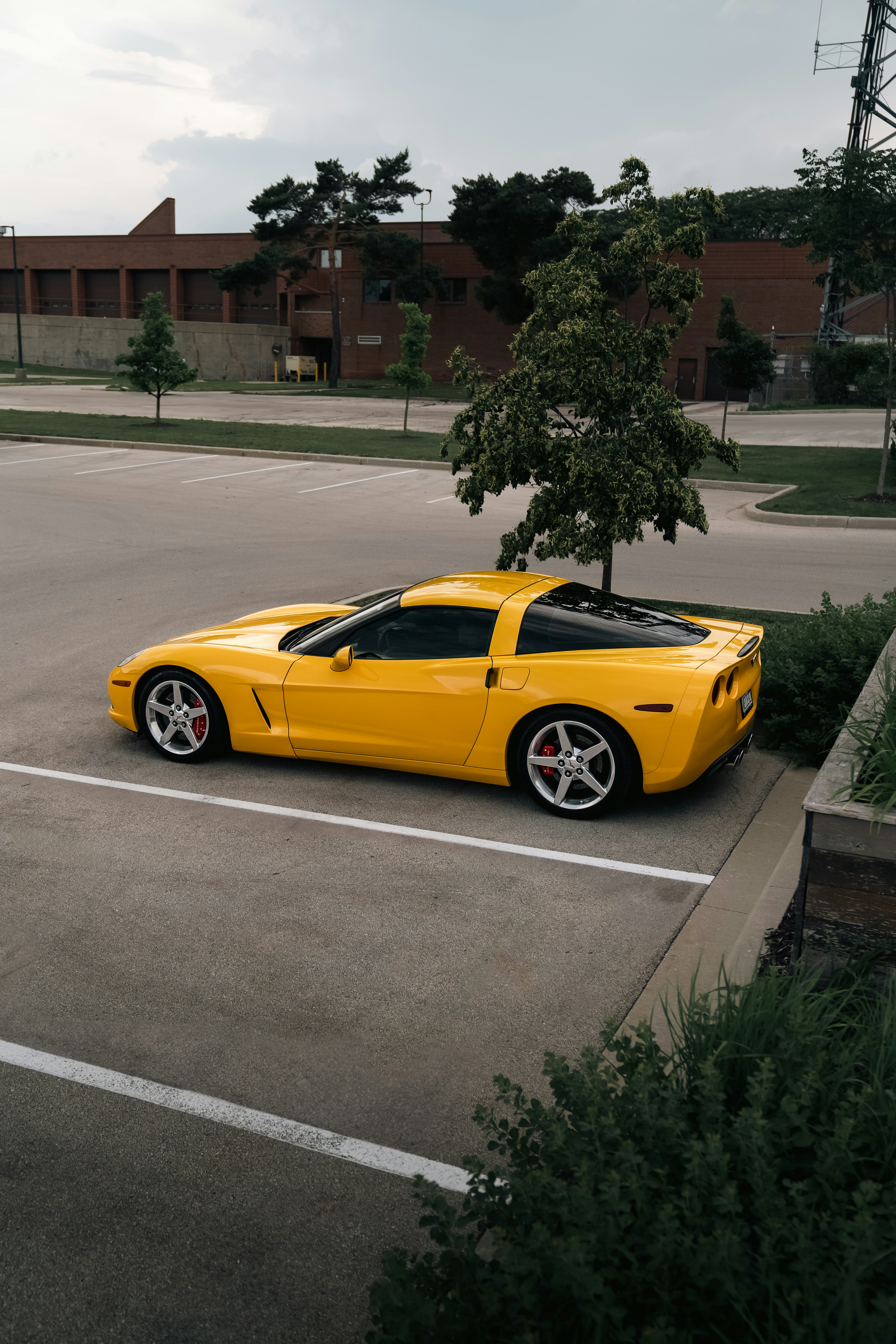 A yellow sports car parked in a parking lot