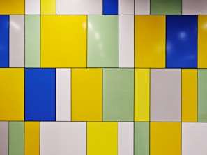 A tiled wall with different colored tiles on it