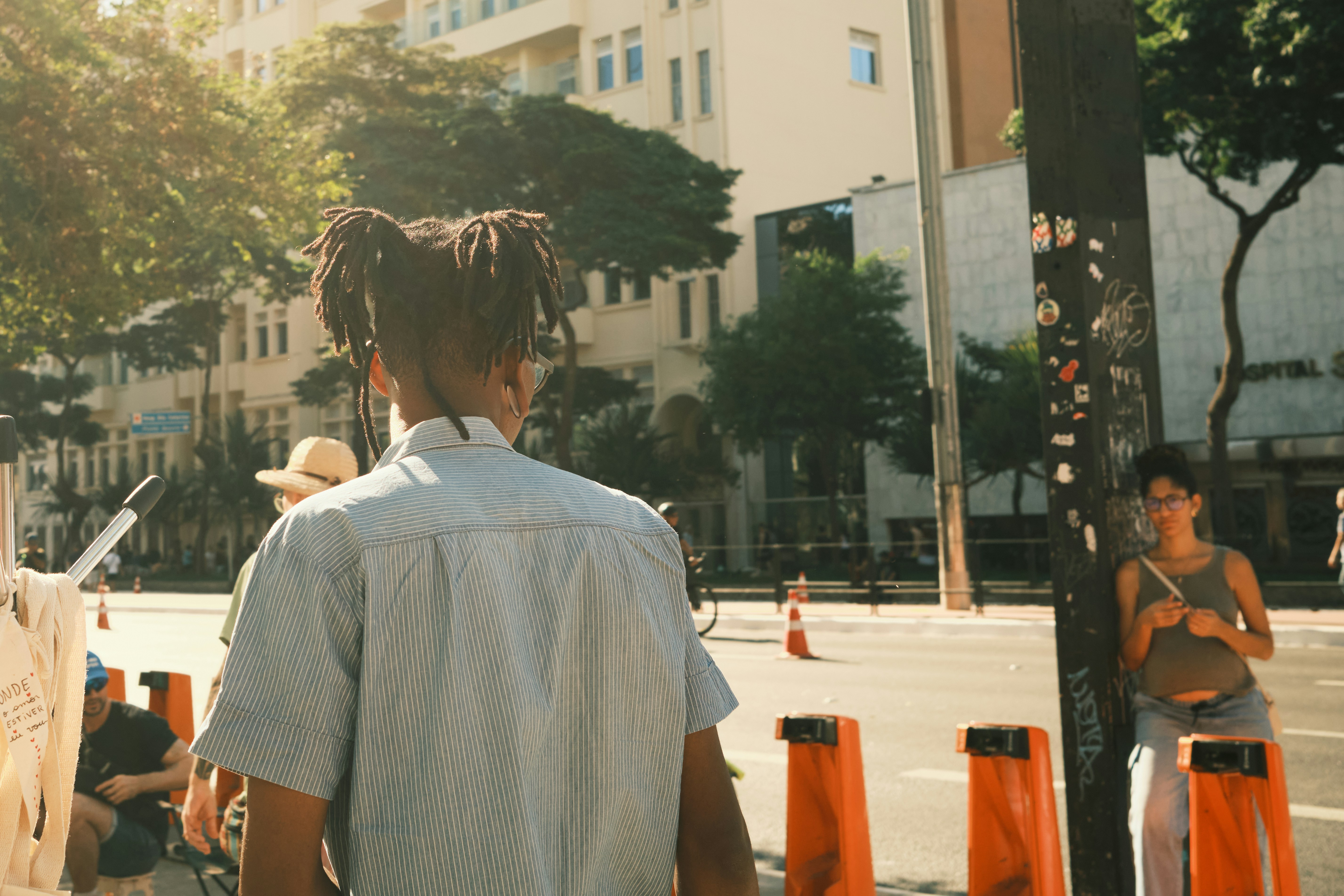A group of people standing on the side of a road