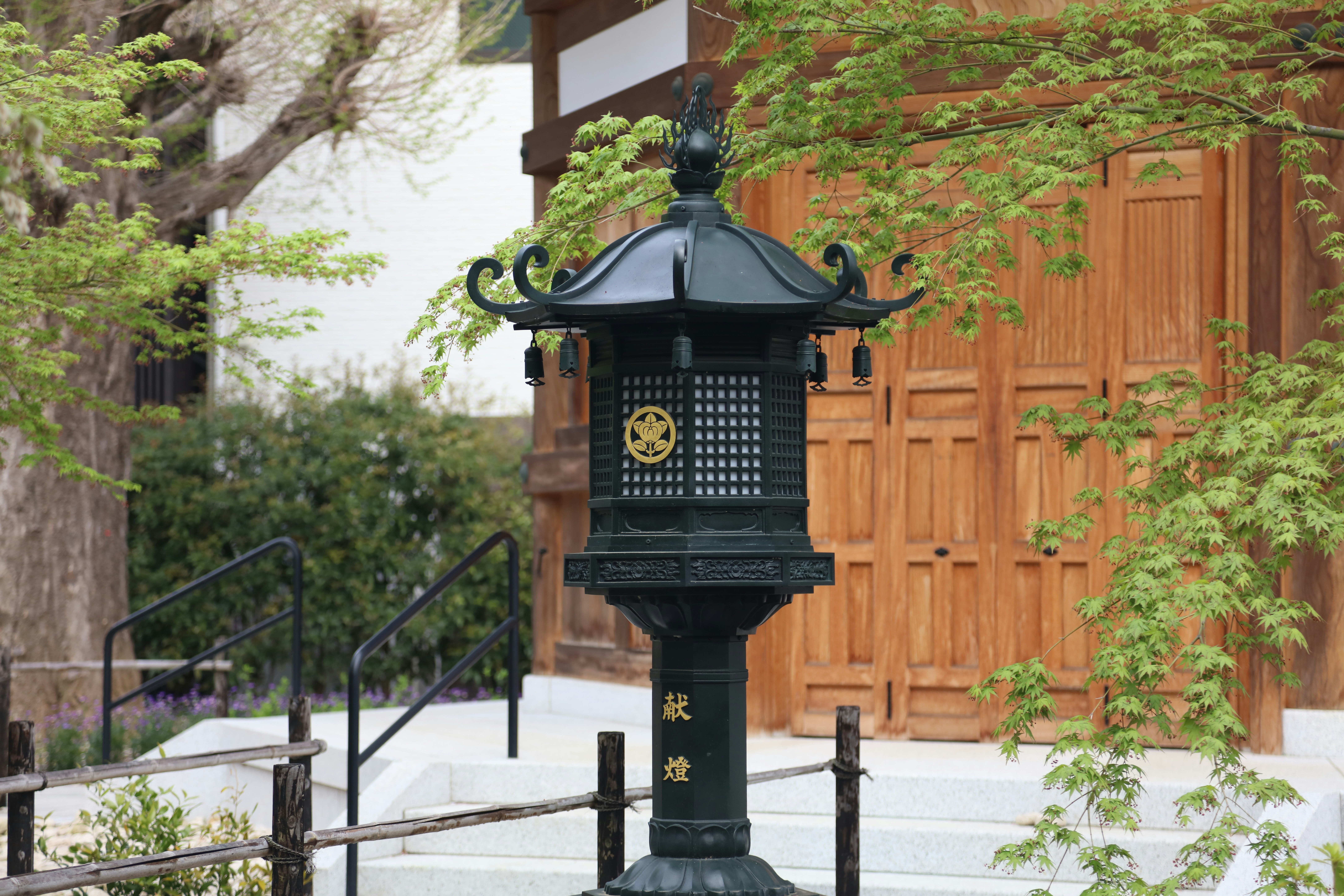 A black lamp post with a clock on top of it