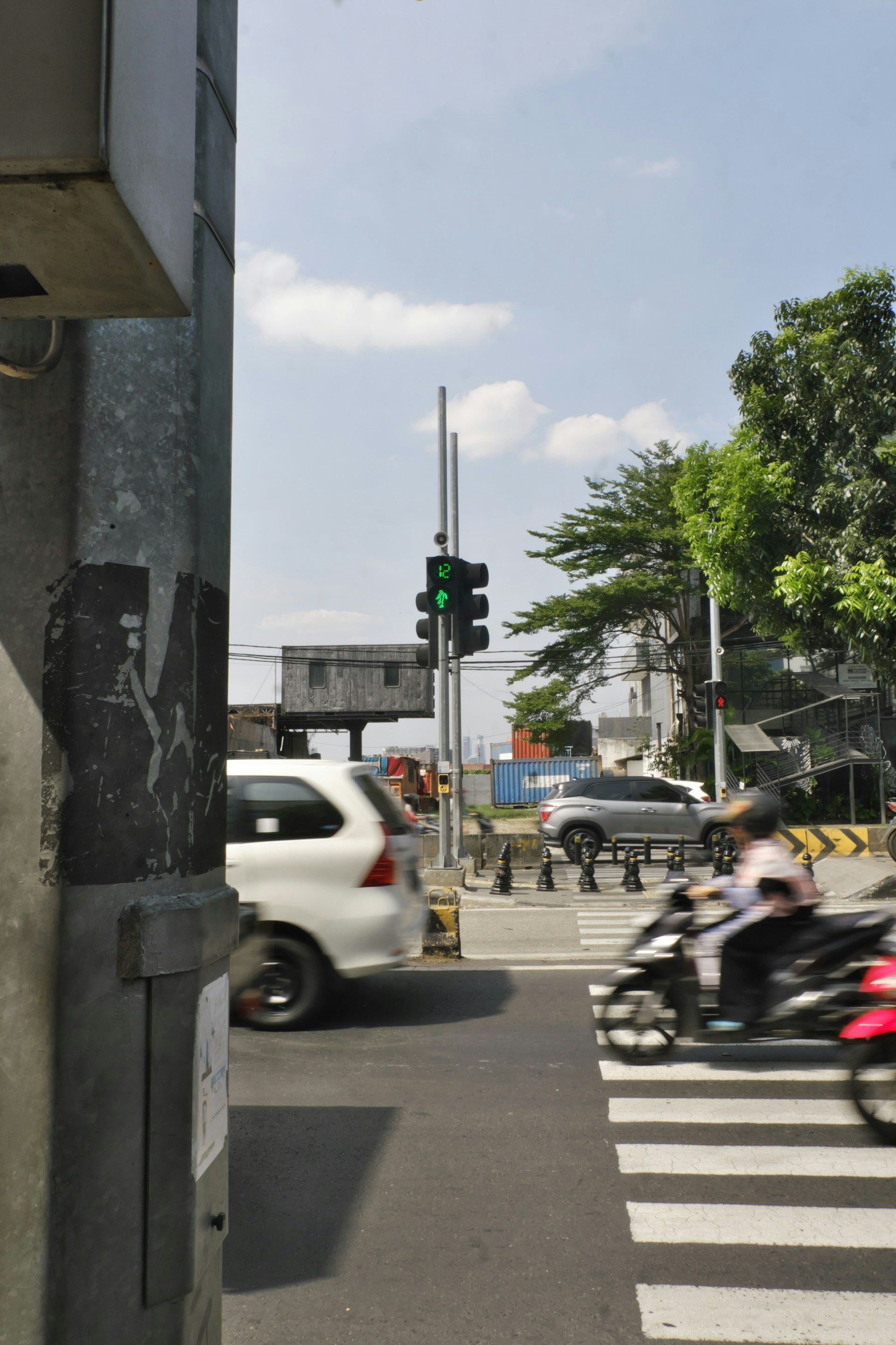 A group of people riding motorcycles down a street