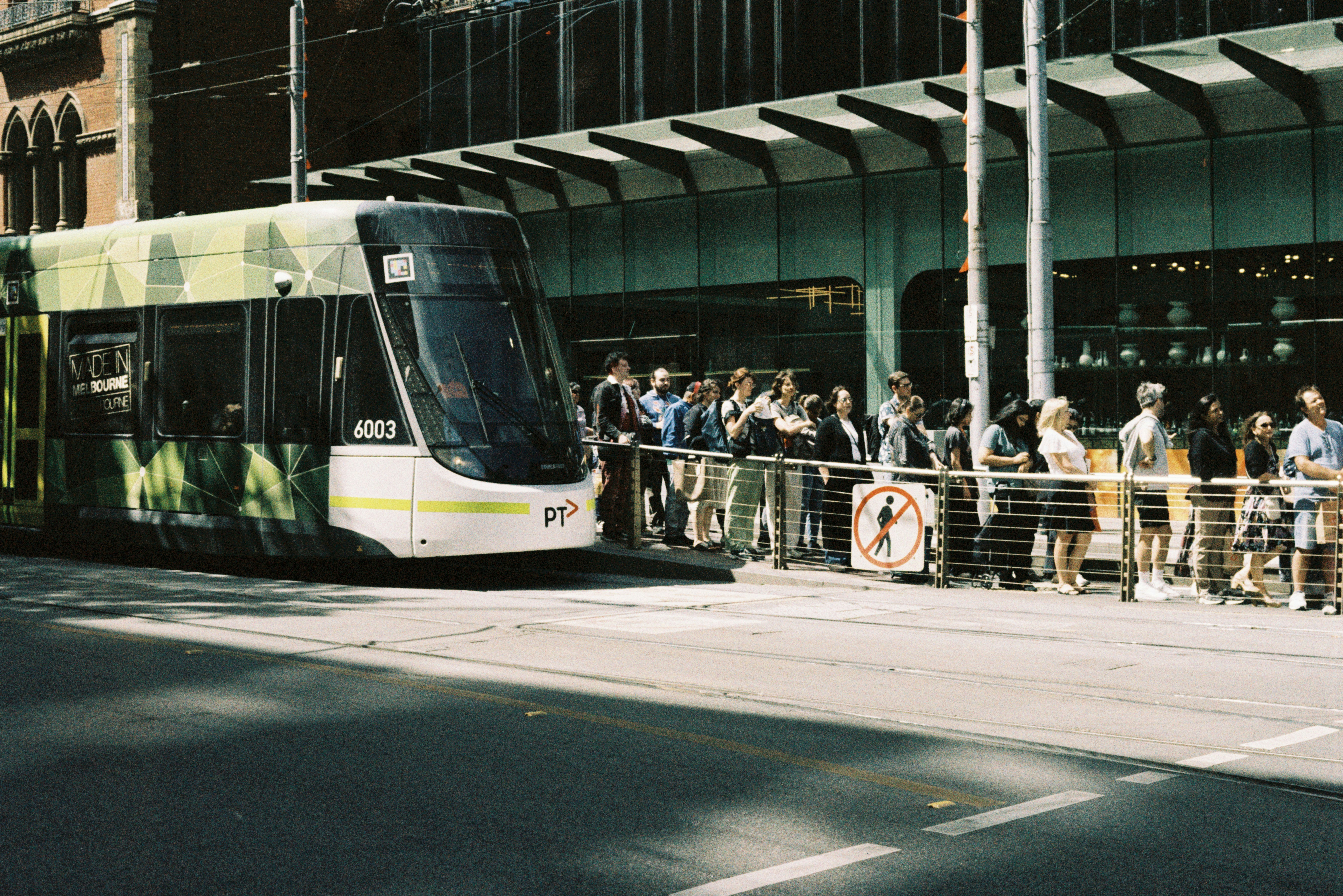 A group of people waiting to board a bus