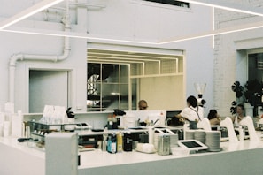 A group of people standing around a kitchen