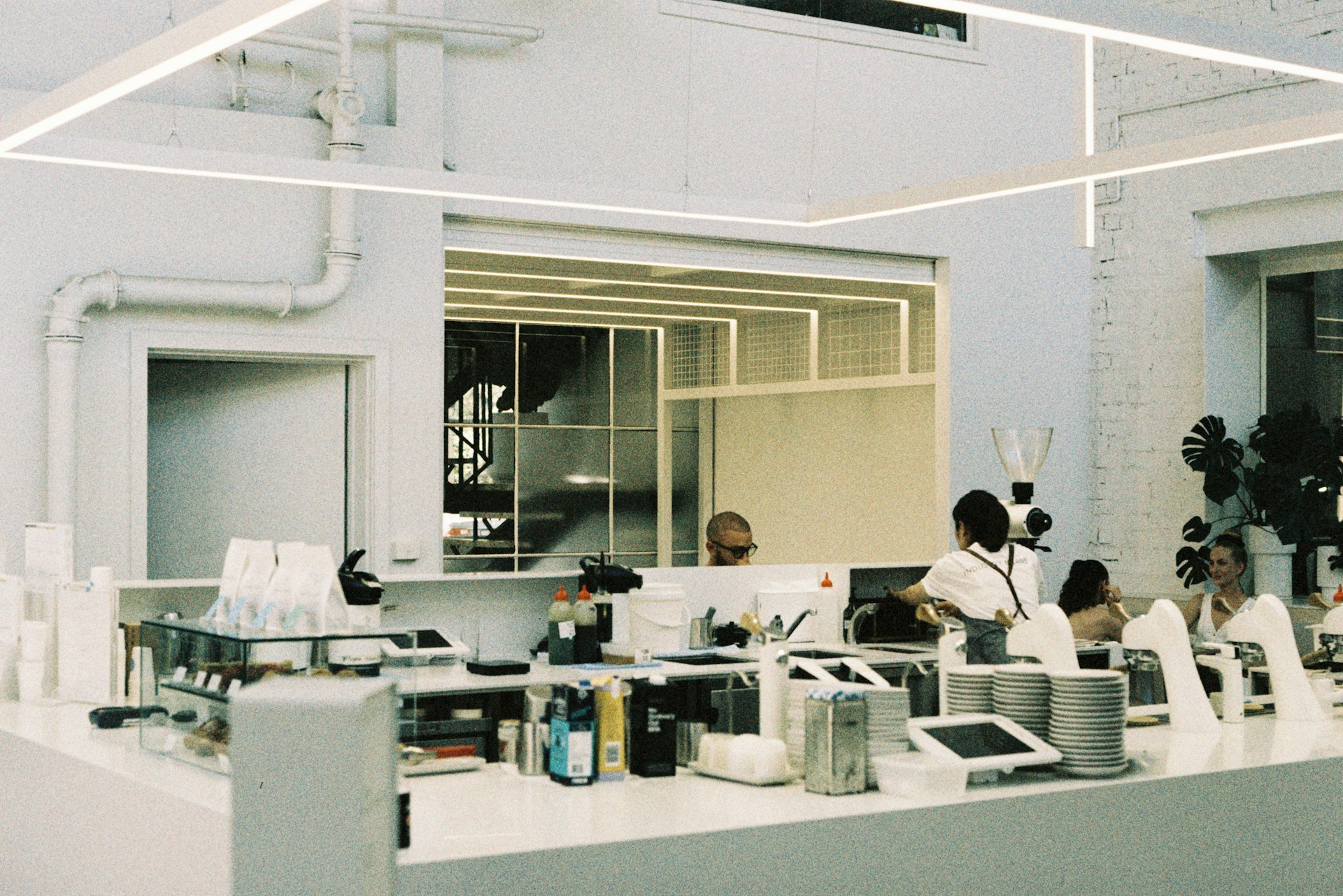 A group of people standing around a kitchen