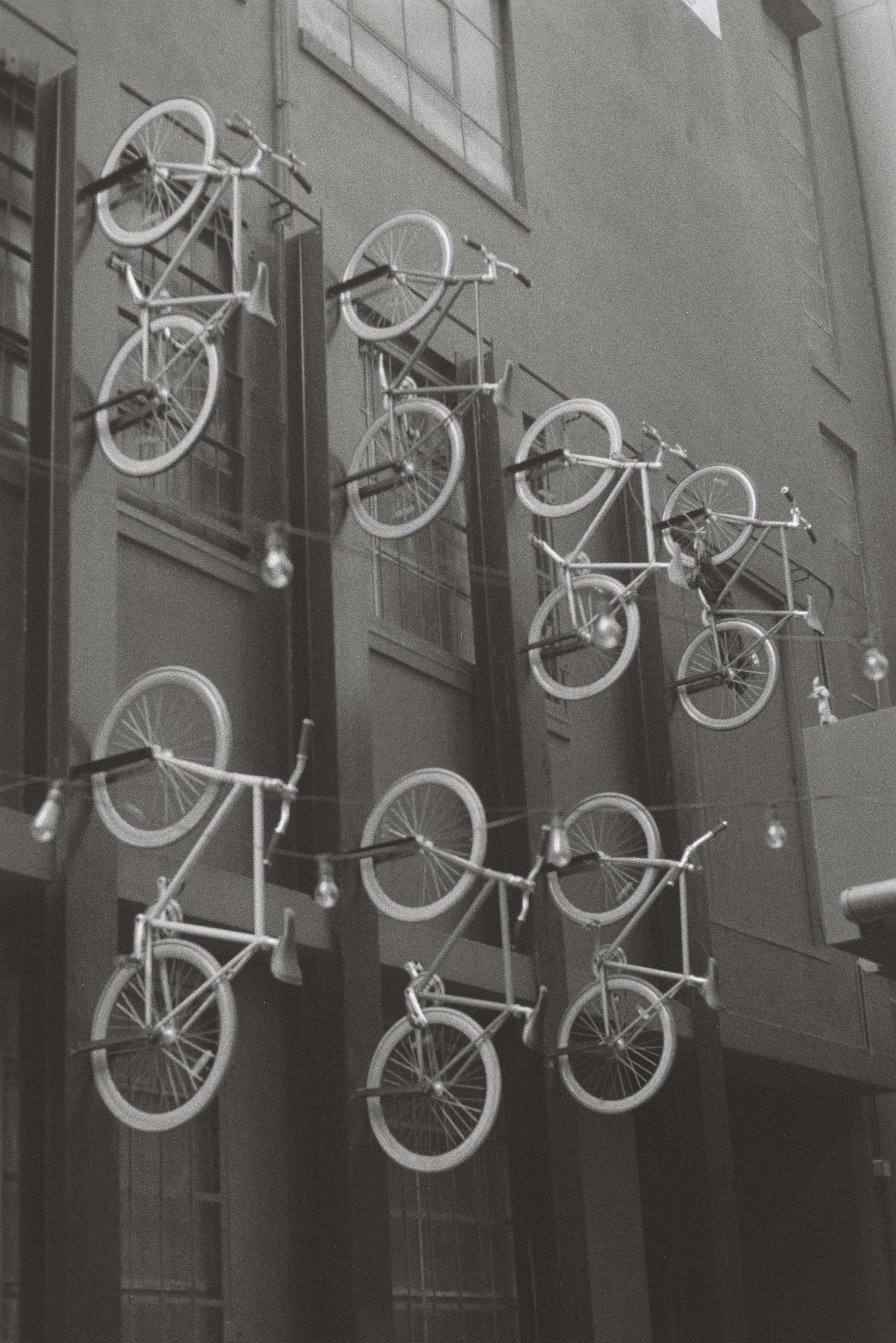 A black and white photo of a building with bicycles on it