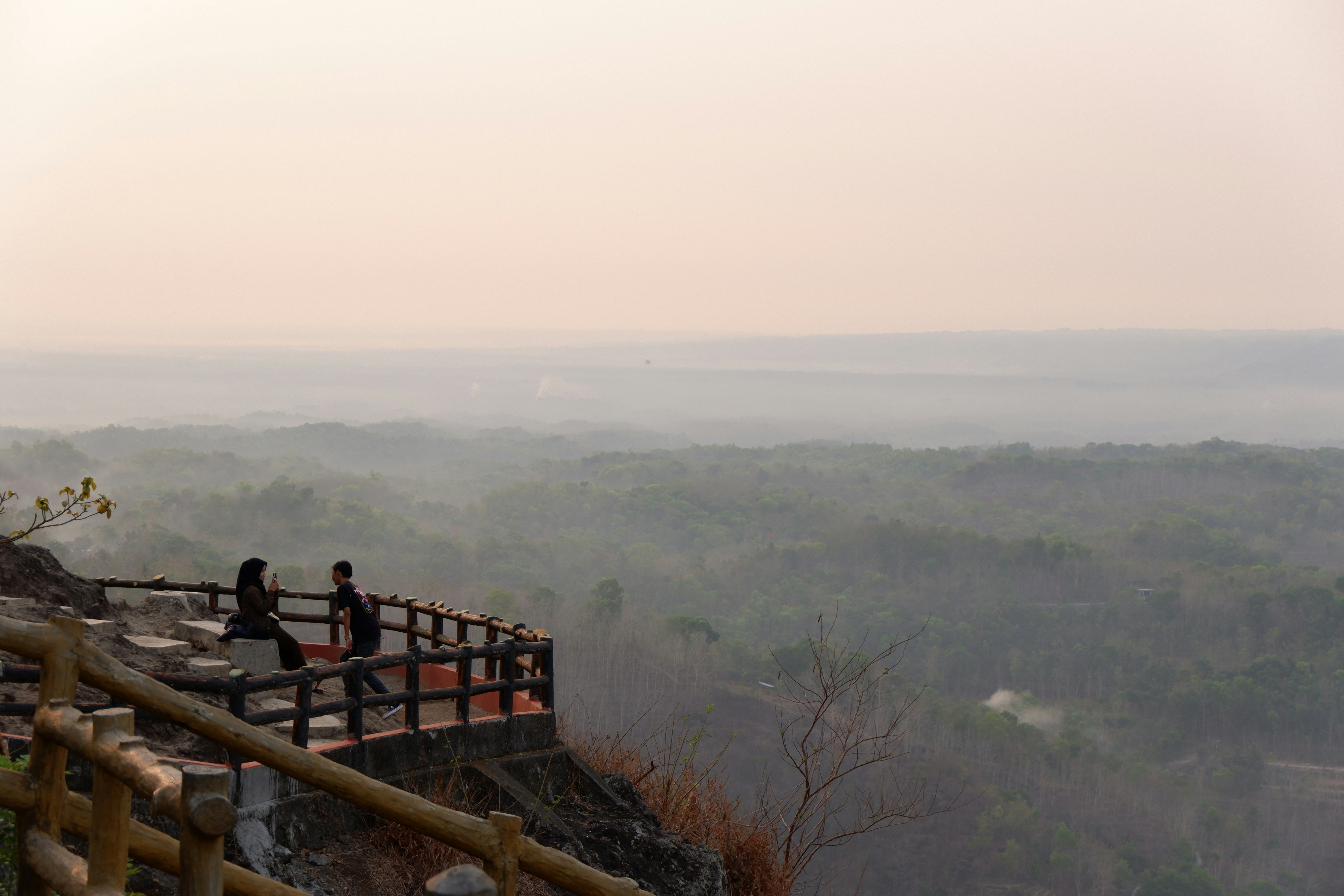 A group of people standing on top of a hill