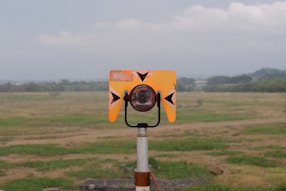 A yellow and black object in a field