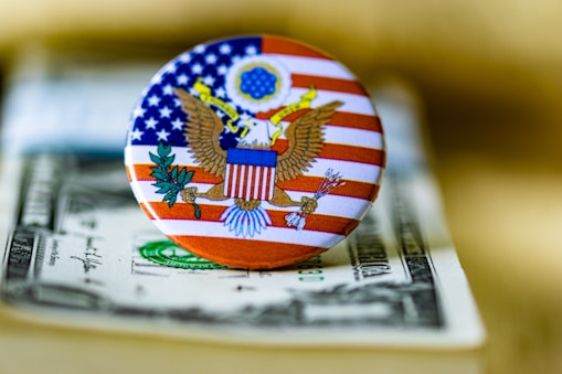 A close up of a button on a dollar bill