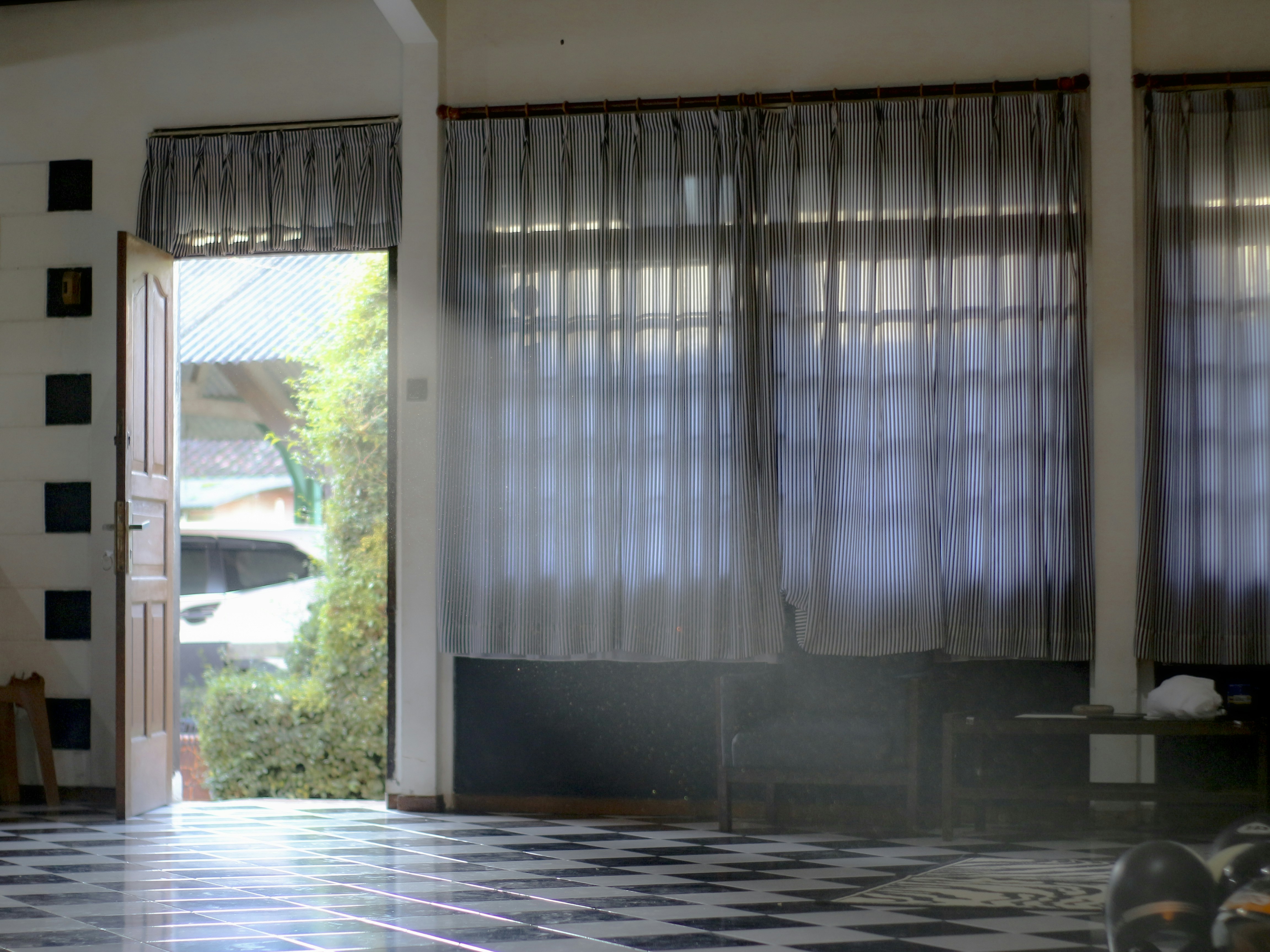 A living room with a checkered floor and a sliding glass door