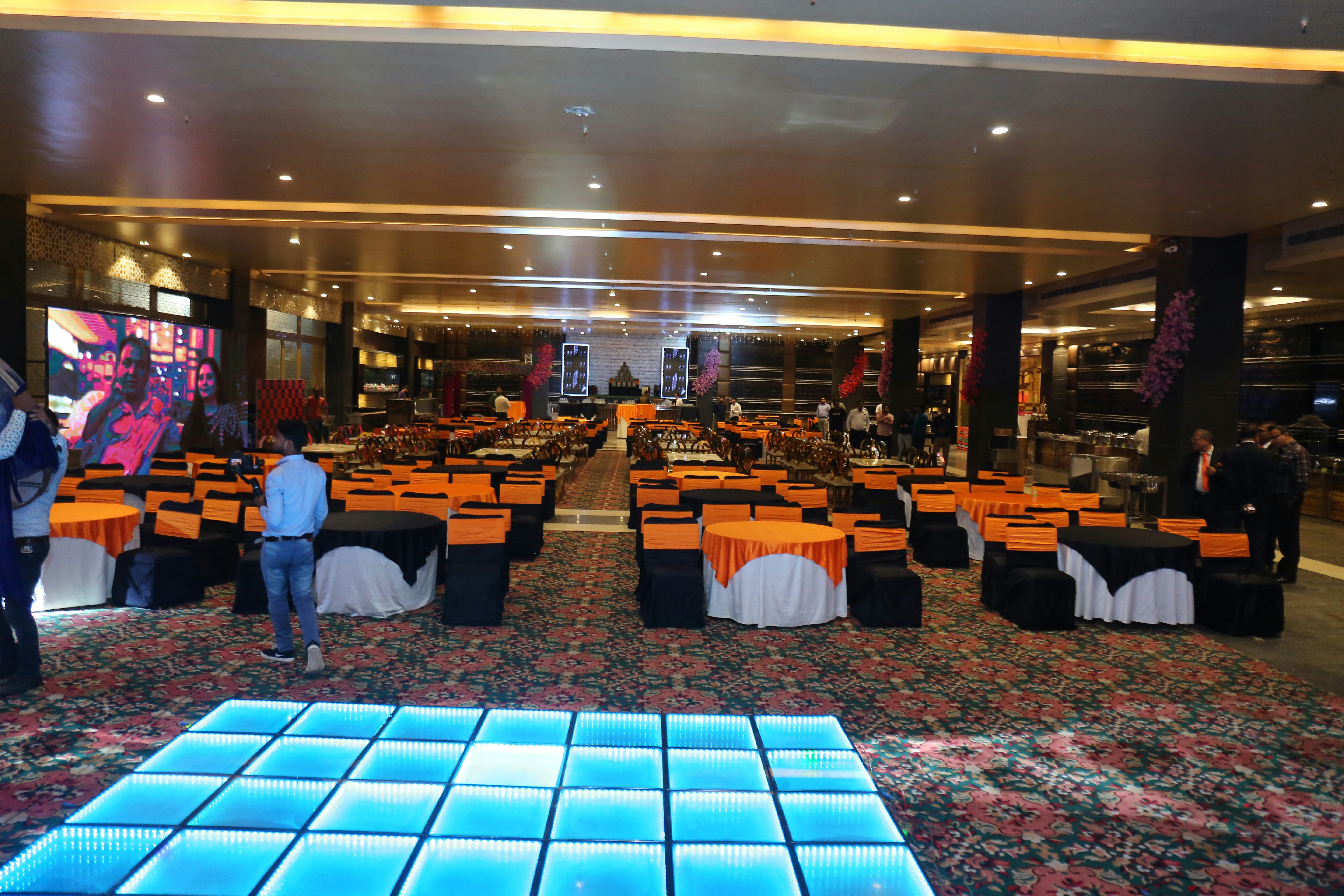 Vibrant indoor party hall with colorful lighting and spacious dance floor