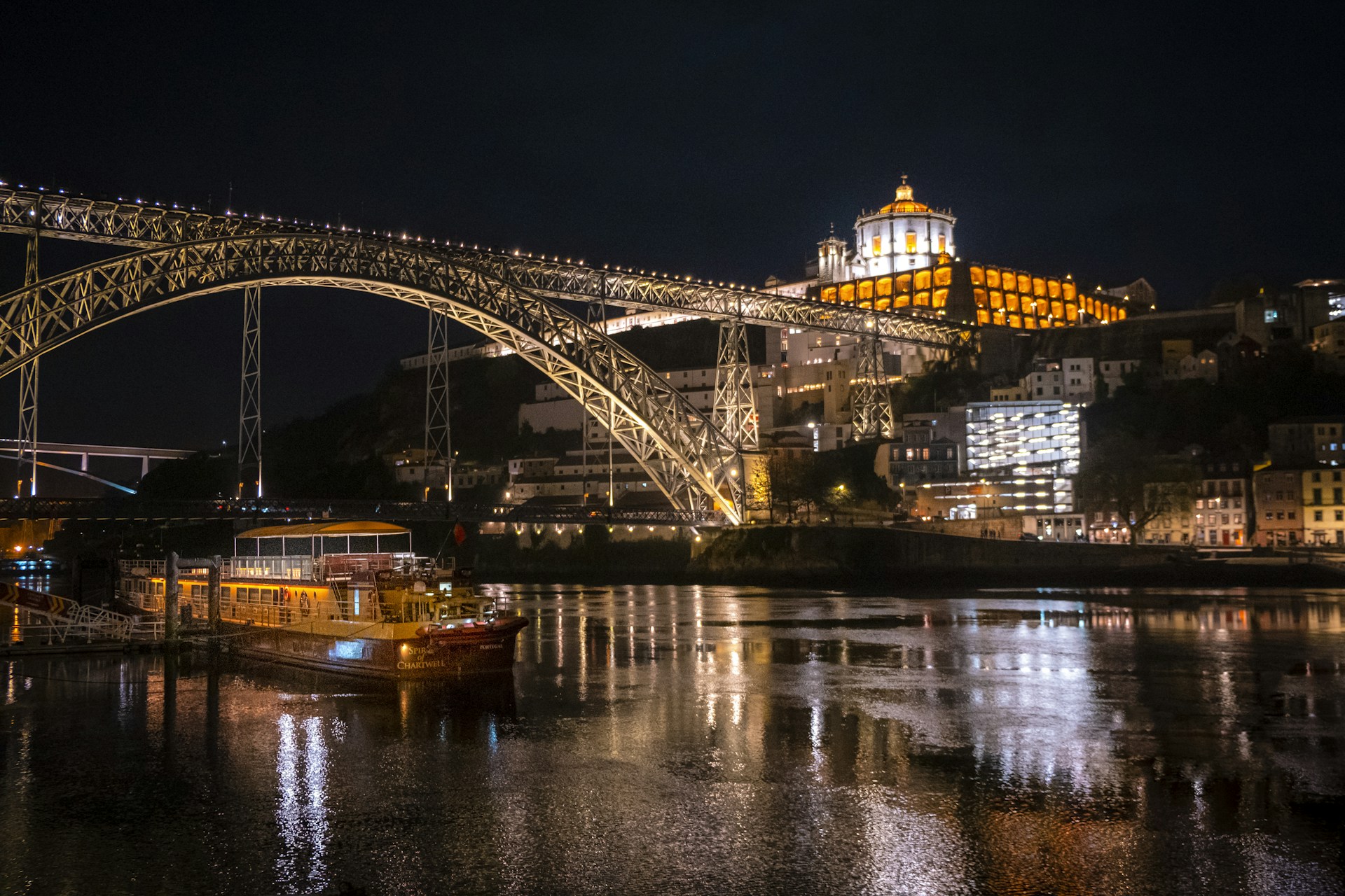 A bridge over a river with a boat in the water