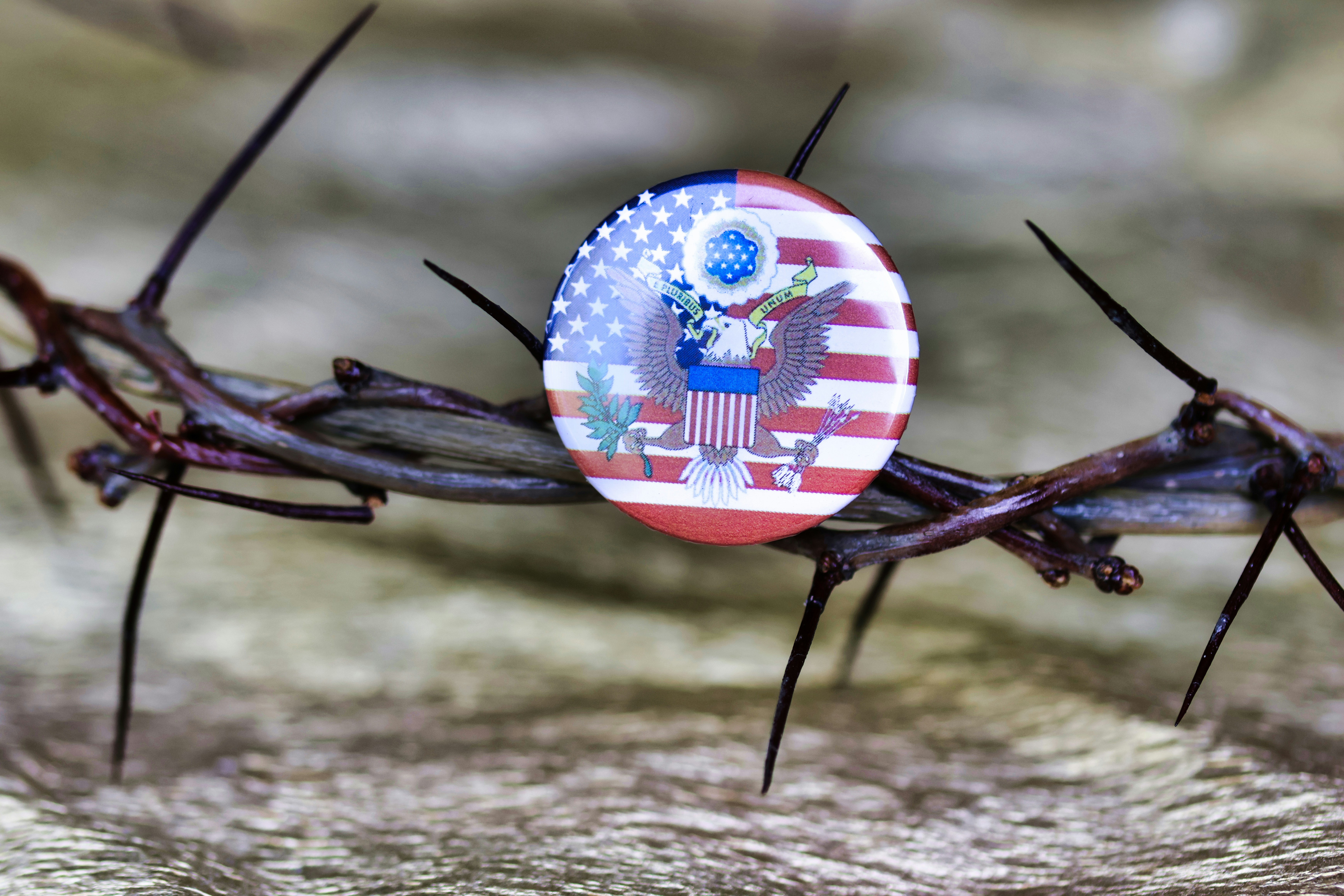 A crown of barbed wire with a button on it