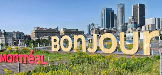 A sign that says bonjou in front of a city