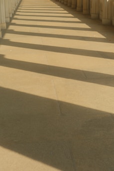 A row of white pillars on a sidewalk