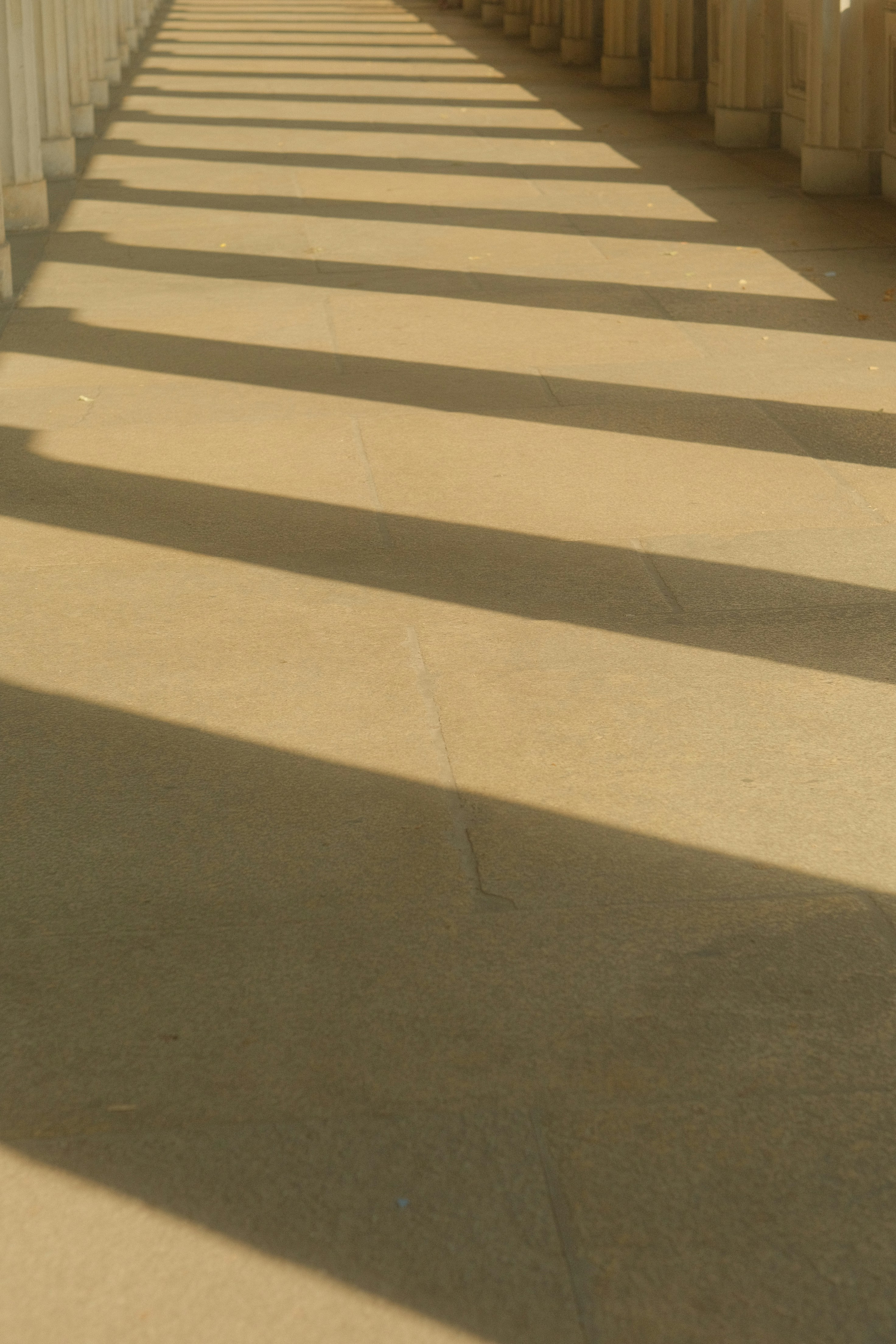 A row of white pillars on a sidewalk