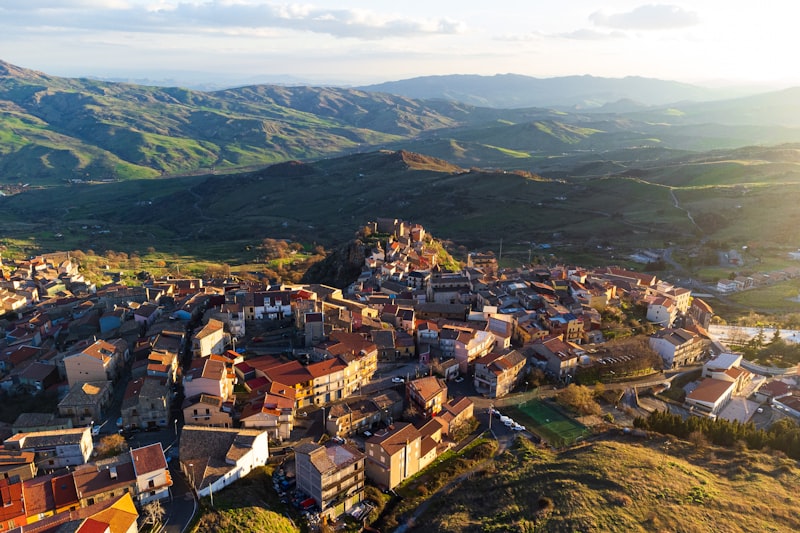 Tuscan hilltop town with rolling hills and distant landscape