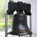 A large metal bell sitting on top of a table