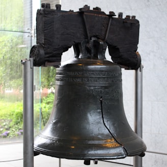 A large metal bell sitting on top of a table