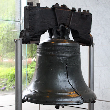 A large metal bell sitting on top of a table