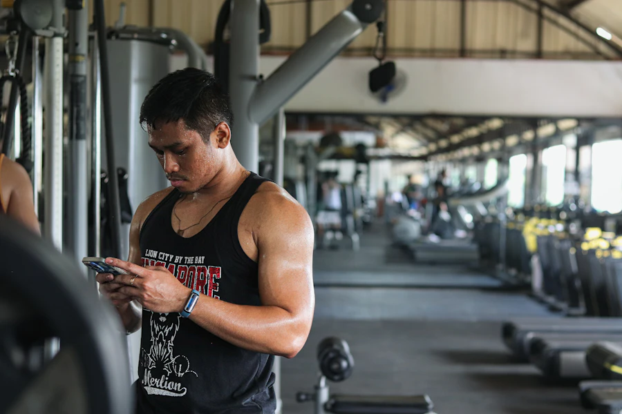 Gym-goer checking a workout on his phone