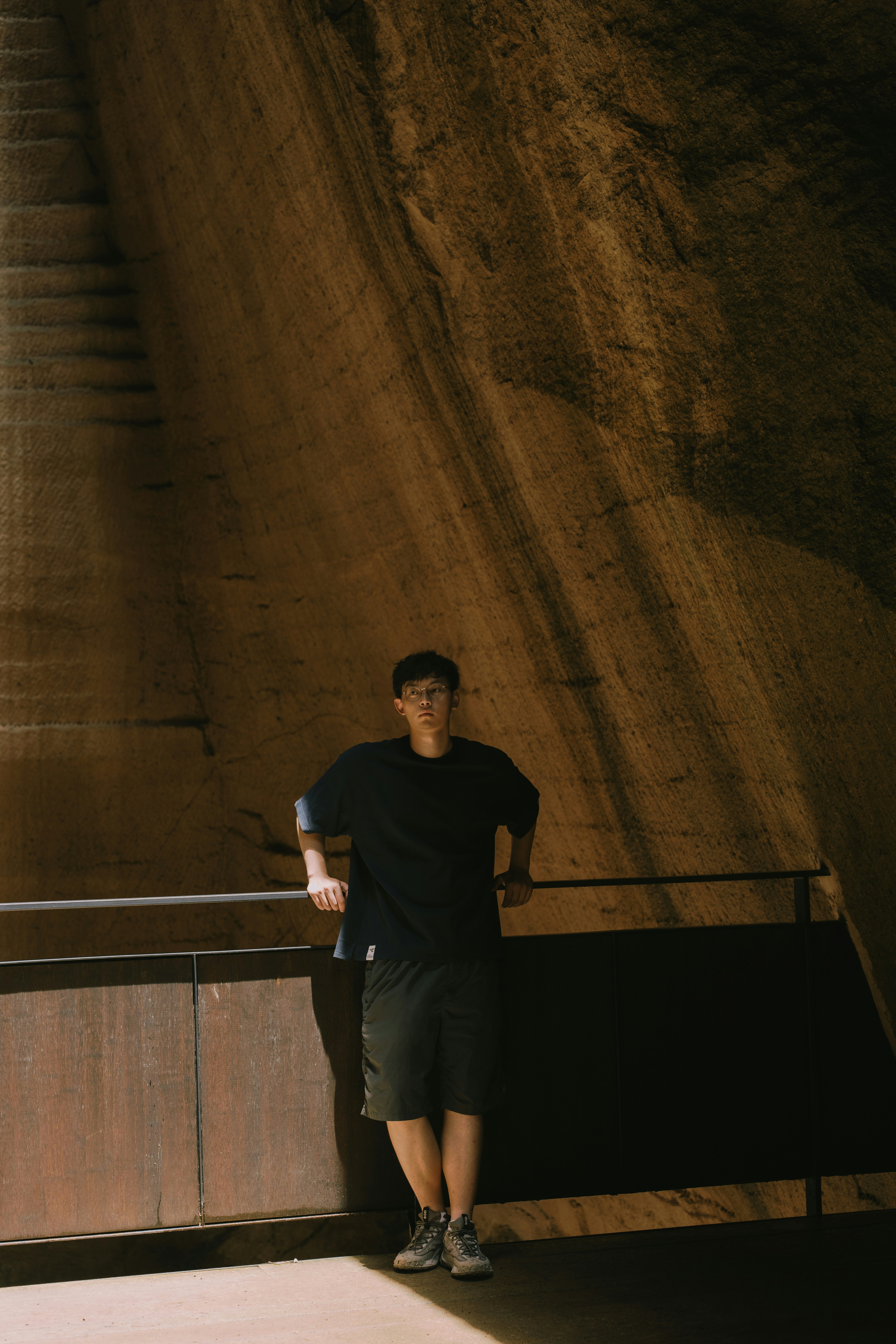 A man standing next to a stair case